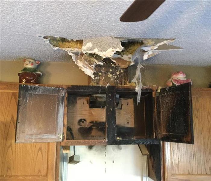The remains of cabinets in a residential kitchen after they caught fire