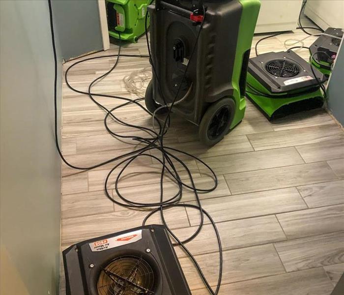 SERVPRO equipment drying the water damage in a laundry room of a Des Plaines home.