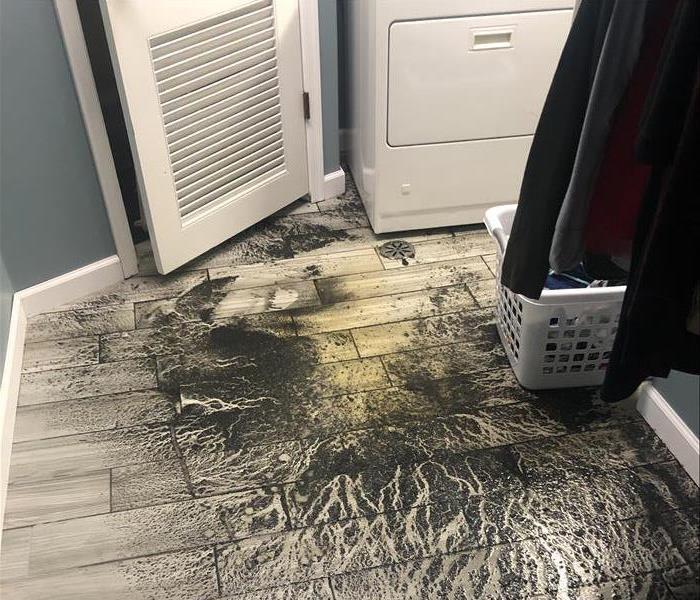 Left over dirt in laundry room from a flooding incident due to heavy rains
